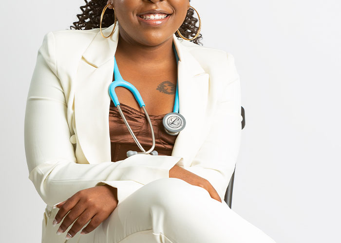 Person in a white suit with a stethoscope, smiling confidently, representing humor in everyday life.