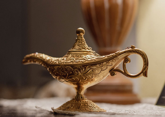 Ornate brass lamp with intricate designs, reminiscent of classic funny genie jokes.