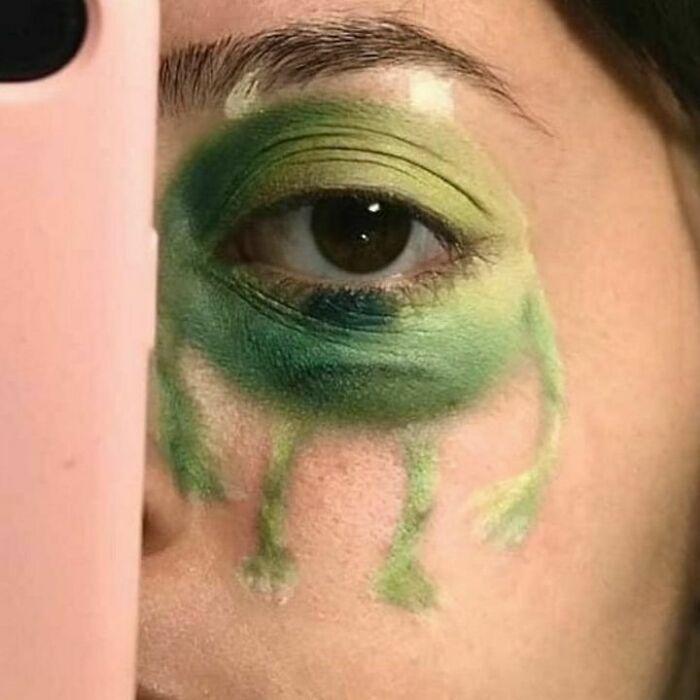 Close-up of an eye with green eyeshadow, resembling a frog, representing images that are hilariously context-free.