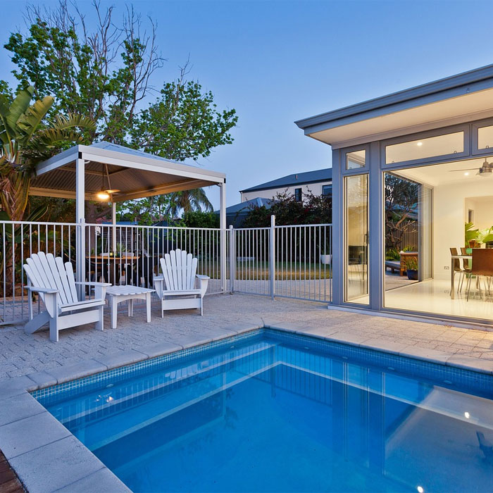 Pool with white chairs near