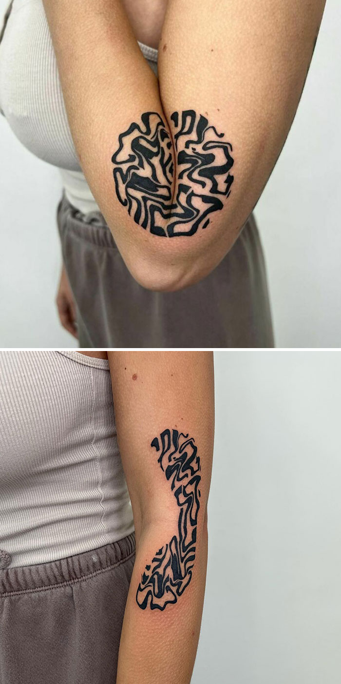 Creative artist's tattoo with hidden meaning on a person's arm, featuring abstract black line patterns.