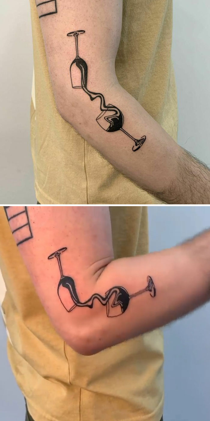 Creative tattoo of a wine spill illusion on arm, showcasing hidden meanings.