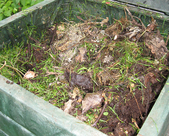 Branches and grass-filled compost box Branches and grass-filled compost box