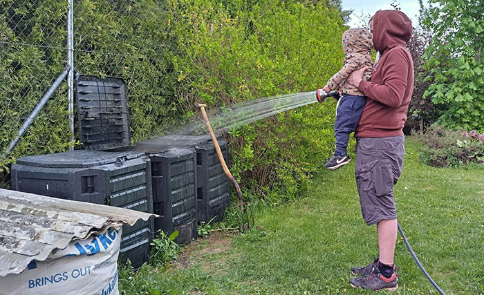 baby watering a compost box baby watering a compost box