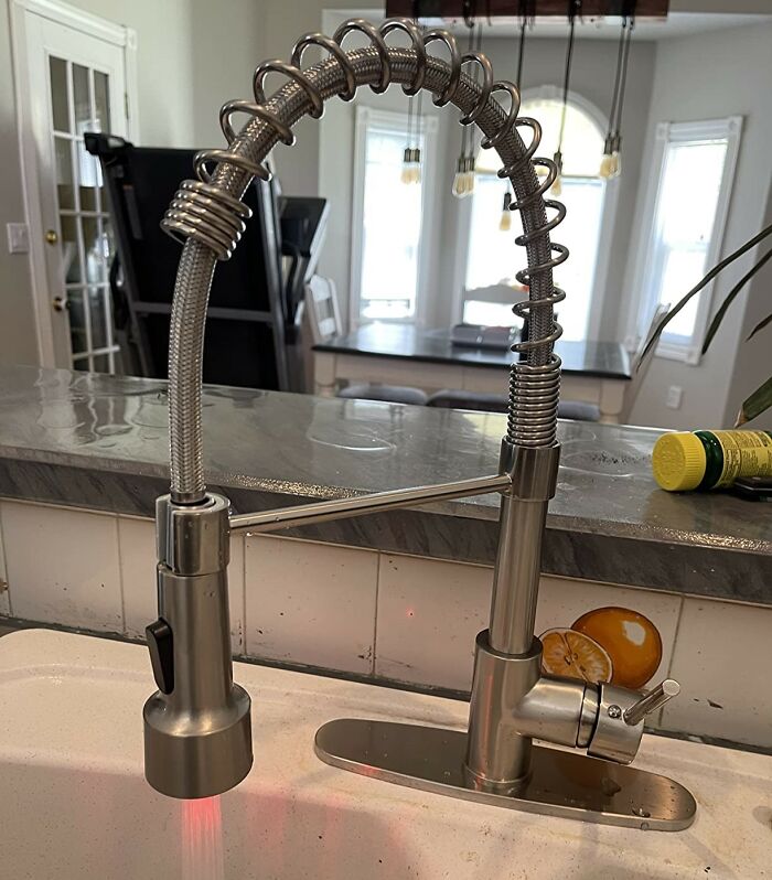 Modern stainless steel spring faucet over sink, smart upgrade to make kitchen feel like new