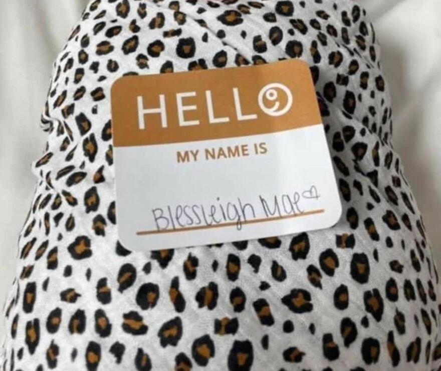 Name tag reading "Blessleigh Mae" on leopard print fabric, highlighting unfortunate names.