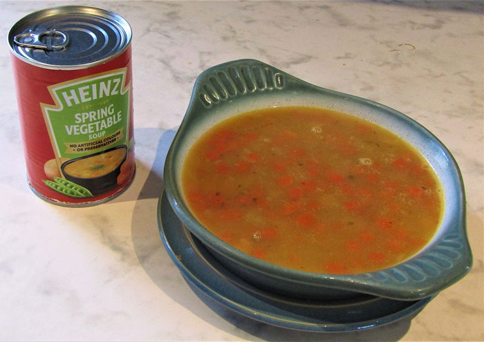 Can of Heinz spring vegetable soup next to a bowl of soup, illustrating weird and fun facts about food products.