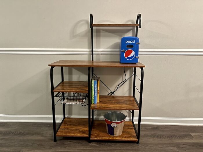 Wood and black metal kitchen shelving unit with mini Pepsi fridge, books and bucket, kitchen feel like new