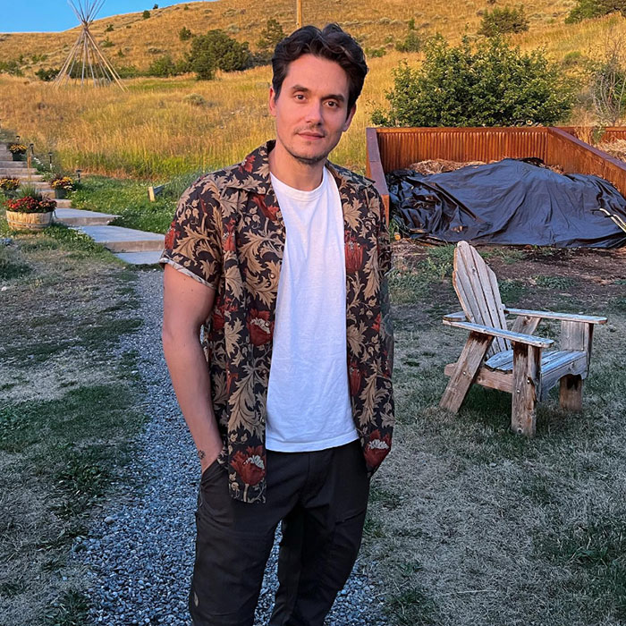 Man in a floral shirt stands outdoors, highlighting pre-cancel culture era.