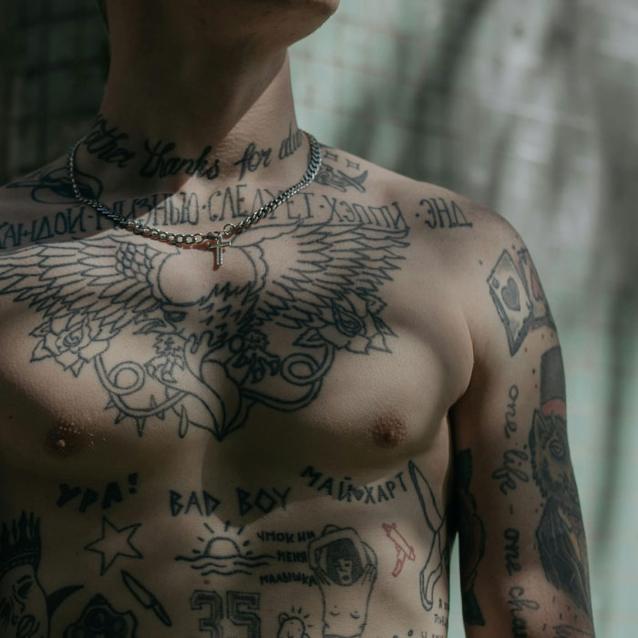 Heavily tattooed male torso with various designs related to tattoo ink ingredients. Heavily tattooed male torso with various designs related to tattoo ink ingredients.