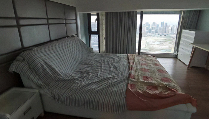 Minimalist apartment bedroom inside a large Chinese dystopian apartment building housing 20,000 residents.
