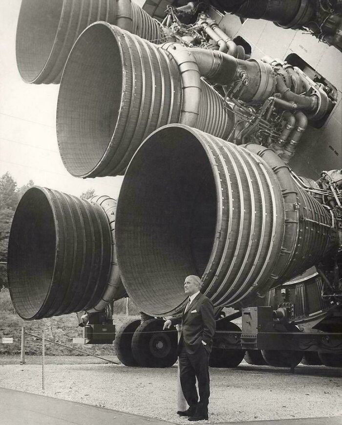 Wernher Von Braun, Designer Of The Saturn V , Poses In Front Of Its Engines (1969). Braun Was The Head Of The German Rocket Industry In World War II. At The End Of The War, He Was Brought To The US