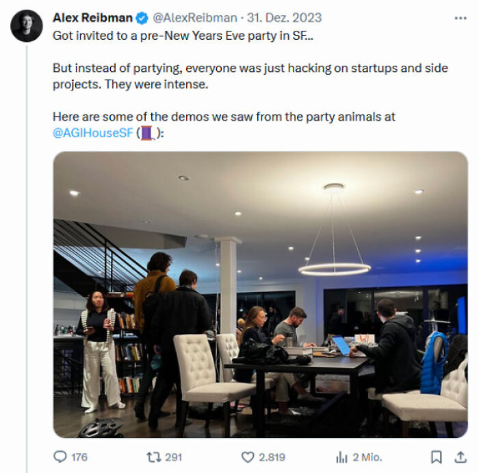 Group of people intensely working on laptops and projects at a modern home, showing hustle culture focus.