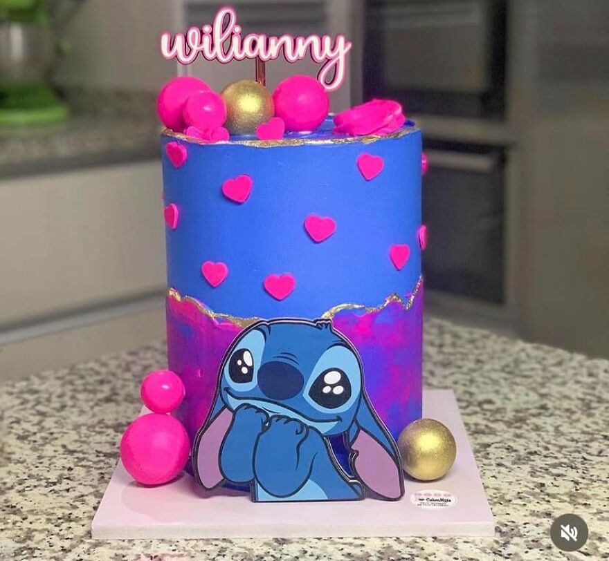 Cute cake for child Wilianny with hearts and a cartoon character on a kitchen counter.