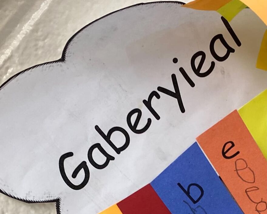 Unfortunate name sign saying "Gaberyieal" with colorful paper background.