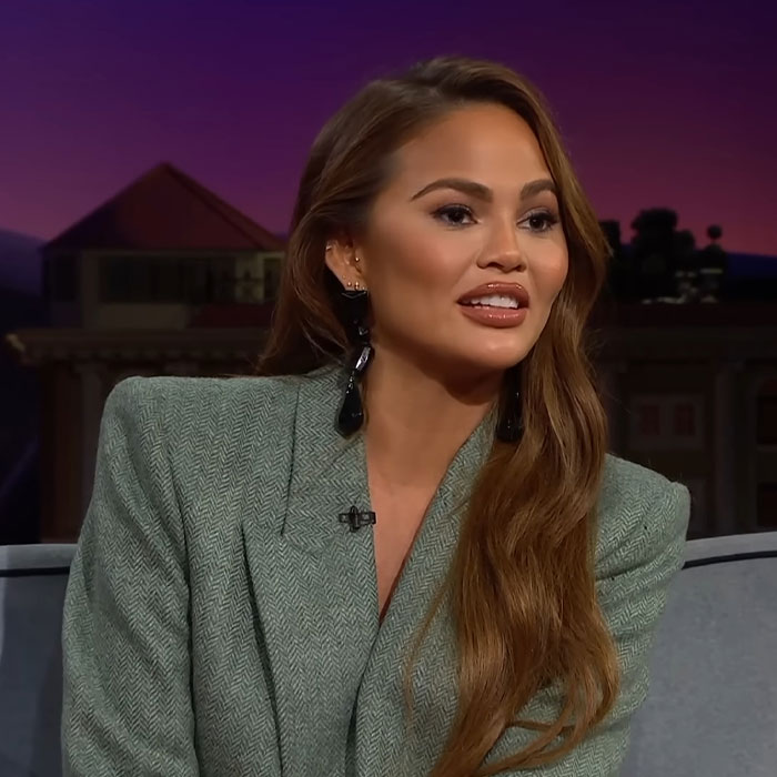 Woman in a green blazer speaking in a studio setting, related to famous people accused of plastic surgery.
