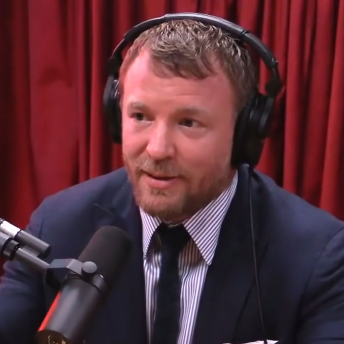 A man in a podcast setting wearing headphones, discussing topics relevant before the age of cancel culture.