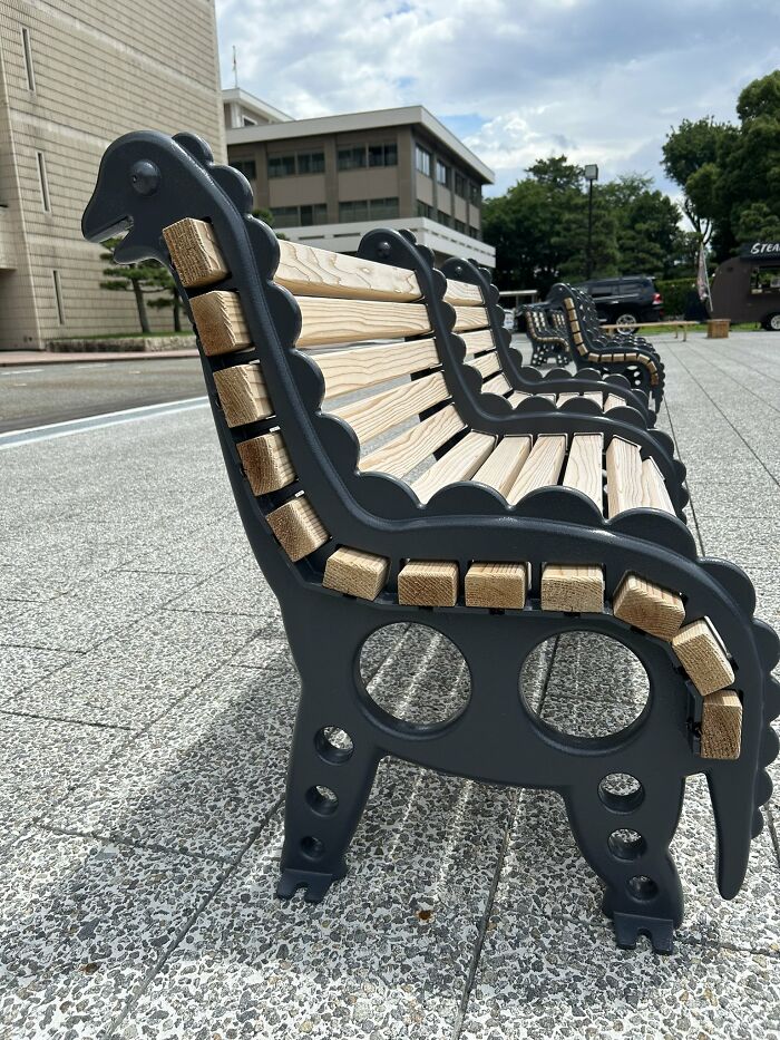 Unique wooden and metal benches with artistic design in a public space, showcasing creative street furniture in Japan.