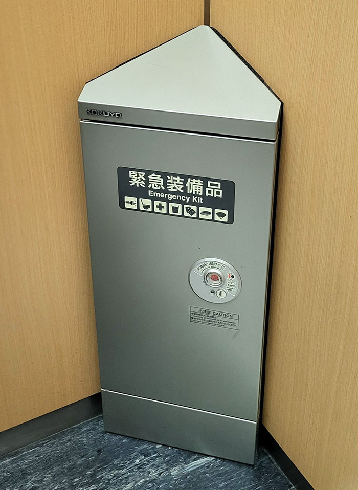 Compact emergency kit in a corner of a Japanese building showcasing practical design in Japan.
