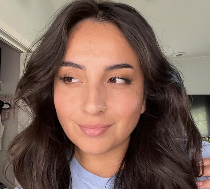 Young woman with glowing skin and natural makeup showcasing beauty brands setting the gold standard in 2024.