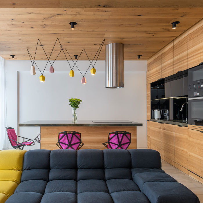 Brown kitchen cabinets near marble table and sofa