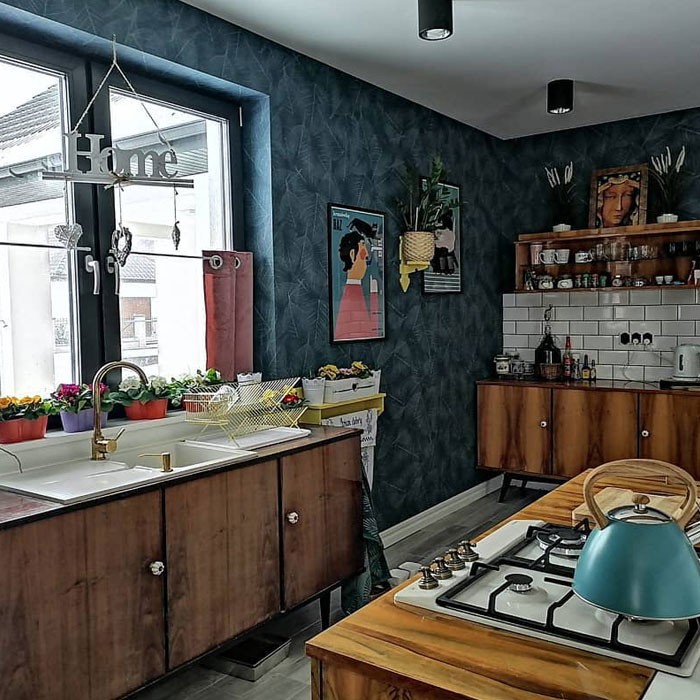 Brown kitchen cabinets near patterned wall