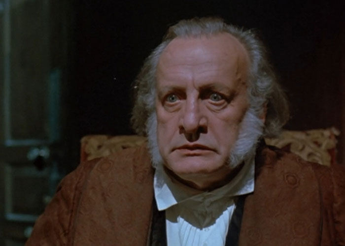 Older man in period costume with white sideburns, portraying a famous person known for declining major awards and honors.