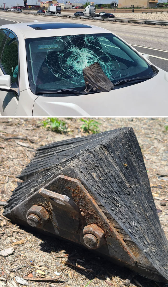 Rusty metal road stopper embedded in c*****d car windshield after collision on highway, a mysterious object found outdoors.