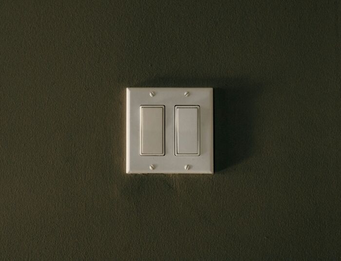 Light switch on a dark wall illustrating simple life advice that people initially thought was a joke but tried.