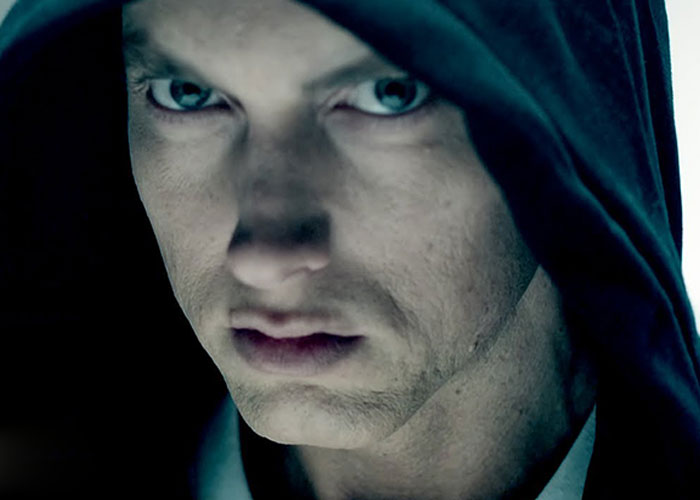 Close-up of a serious person wearing a hood, representing famous people who declined major awards and honors.