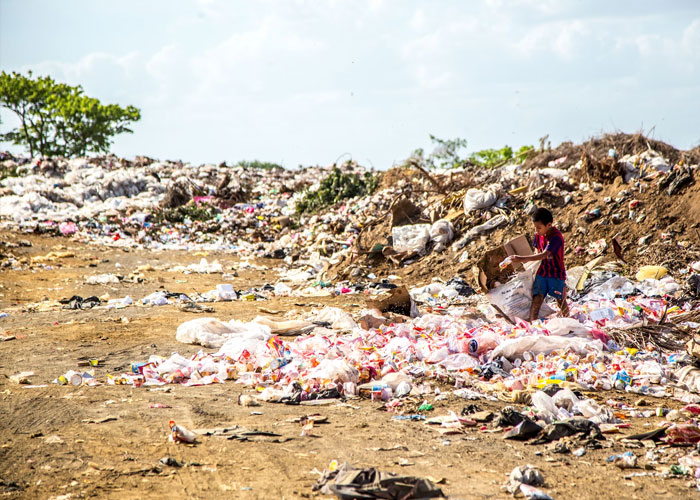 Childfree people over 40 in a waste-filled environment reflecting on life choices and their impact.