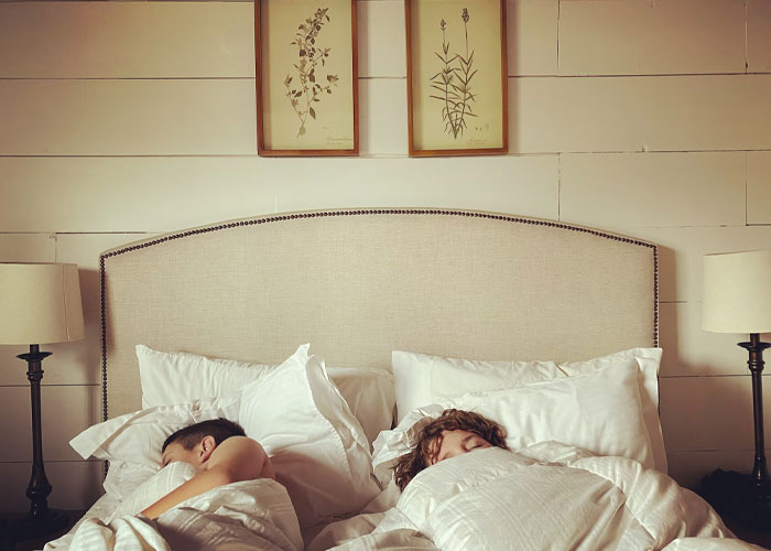 Two people sleeping in a cozy bedroom, illustrating relatable moments people confessed they didn't know until late in life.