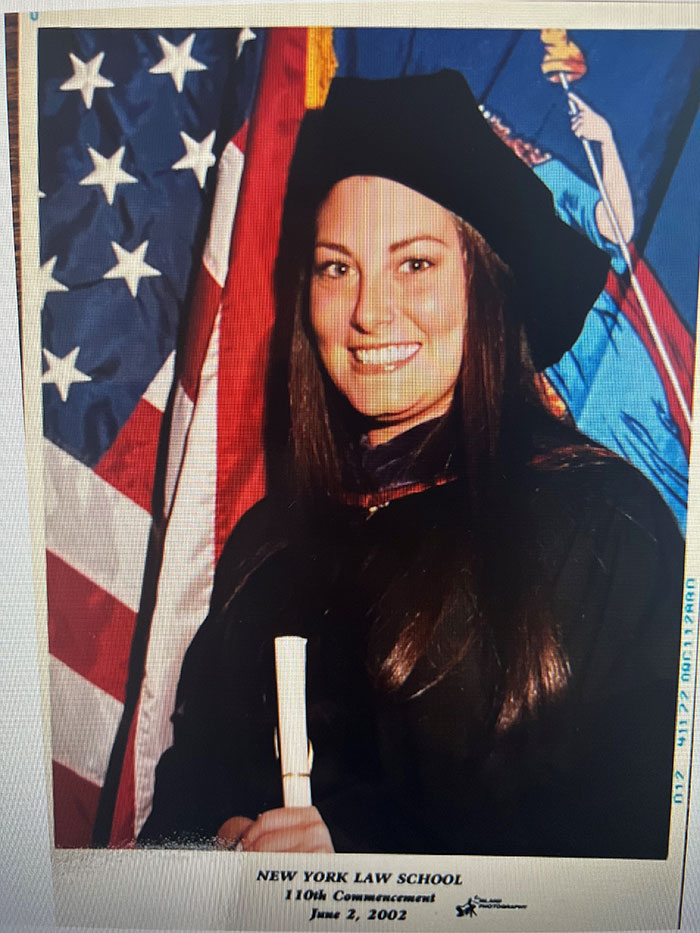 Woman in graduation attire holding diploma in front of American flag, symbolizing rare uterine cancer affecting September 11th victims. Woman in graduation attire holding diploma in front of American flag, symbolizing rare uterine cancer affecting September 11th victims.