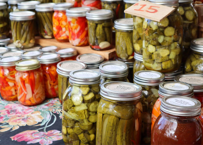 Jars of pickled vegetables on display at a market, highlighting a common embarrassing food discovery late in life.
