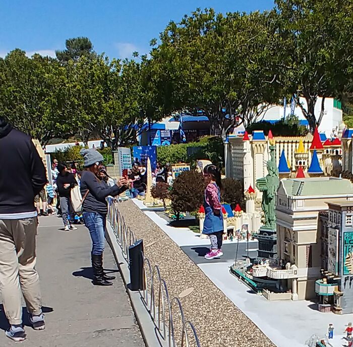 Putting Your Child Next To Fragile LEGO Buildings Despite Numerous Signs Saying Not To