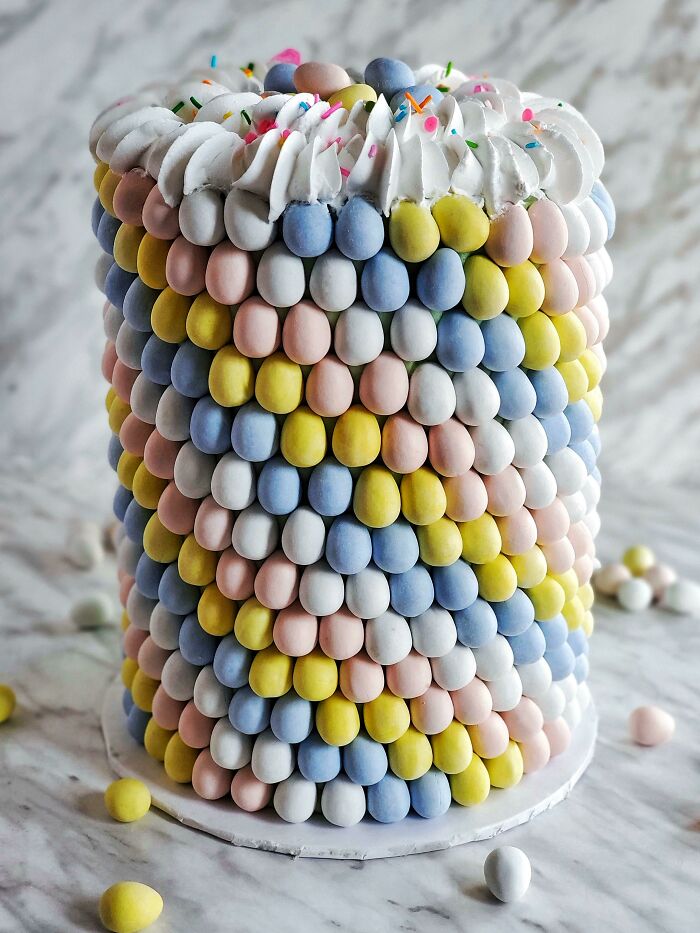 Mini Egg Easter Cake With Alternating Chocolate And Vanilla Layers, Topped With Vanilla Buttercream And Mini Egg Pieces