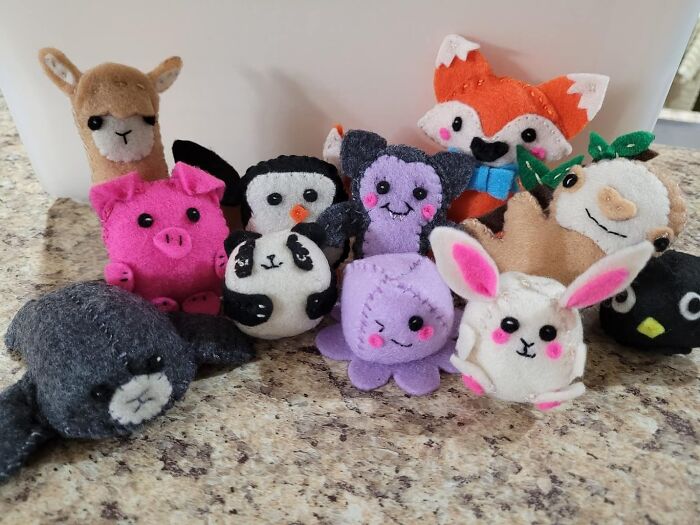 Colorful handmade felt animal toys arranged on a table, showcasing hobbies where trying your best is key.
