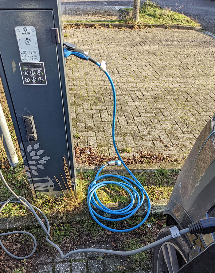 Someone Just Drove Off Forgetting To Take Their Charging Cable, Which Is Locked Into The Charge Port