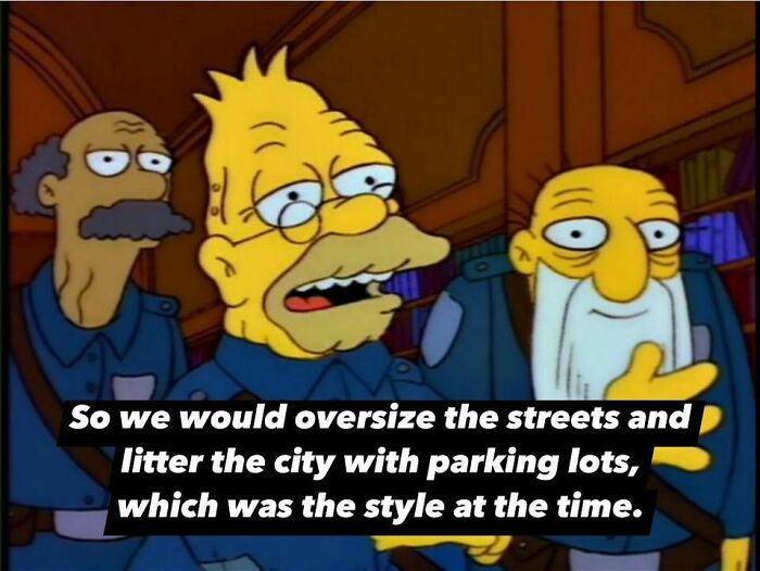 Characters discussing oversized streets and parking lots, highlighting classic urban planning absurdity.