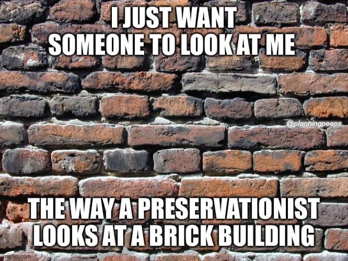 Brick wall with text meme highlighting the absurdity of modern city planning, mentioning preservationists' views on buildings.