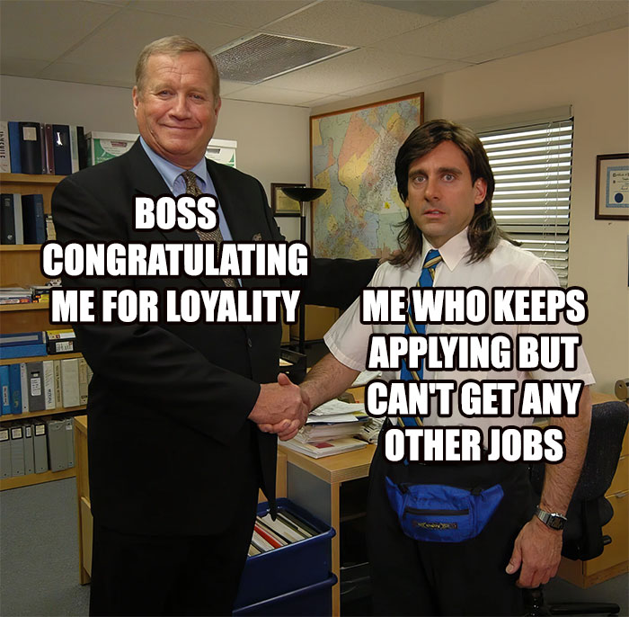 Two men shaking hands, with a humorous work meme about applying for jobs displayed in an office setting.