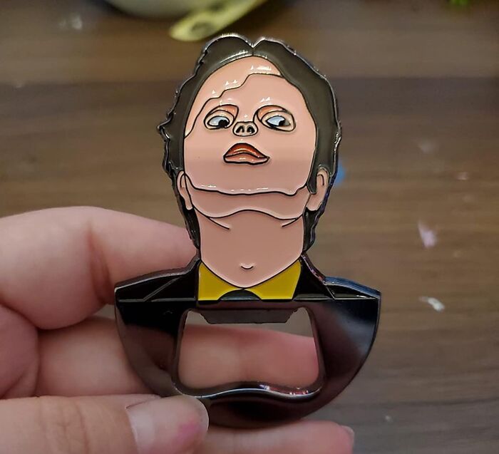 Hand holding a quirky enamel bottle opener featuring a cartoon face, one of the Amazon finds between genius and why exists.