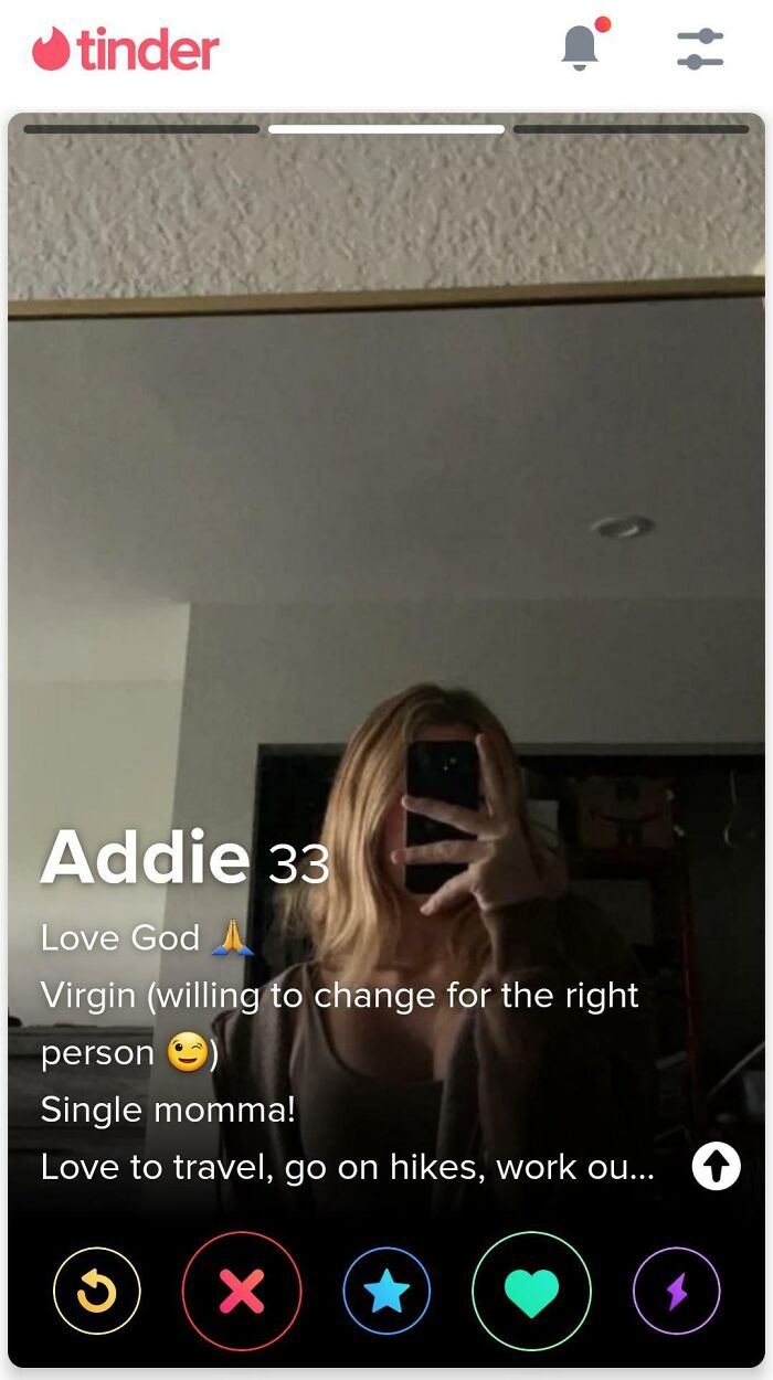 Tinder dating profile selfie showing a woman with blonde hair and bio text, illustrating clueless people surprising others.