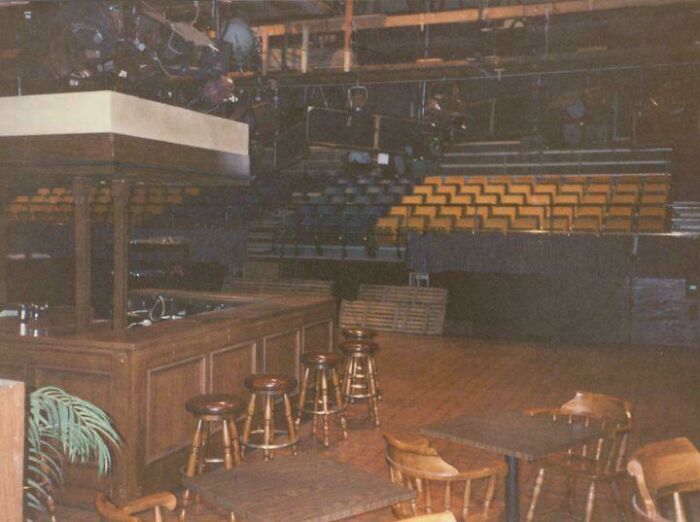 Bar set with stools and tables in an empty studio, offering a new perspective on a famous venue.