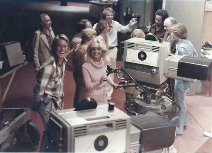 People on a TV set with cameras, providing a new perspective on famous events and places.