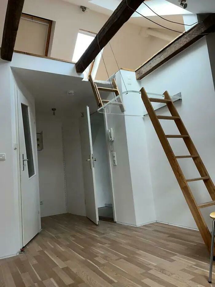 Wooden ladder with unsafe design leading to a loft area, a classic DIY disaster in home renovation projects.