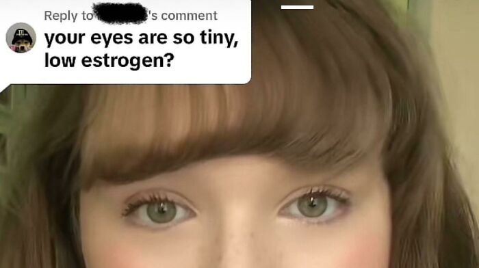 Close-up of a young woman’s face with green eyes and bangs, highlighting a cringe-worthy take on women in comments.