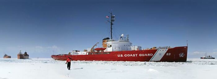 U.S. Coast Guard icebreaker ship navigating through frozen waters showcasing brilliant infrastructure and engineering.