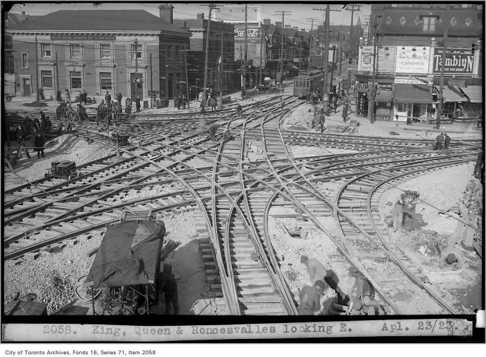 Complex railway intersection under construction with workers, showcasing brilliant infrastructure development in an urban area.
