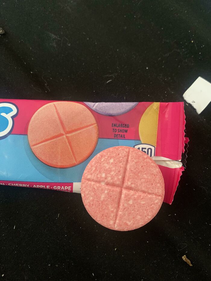 Close-up of a round candy on a package.